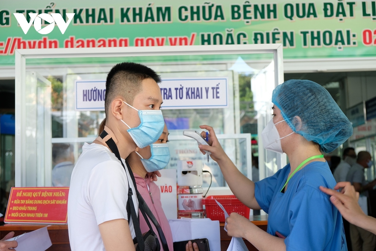 Each person receives a body temperature check at the entrance gate.