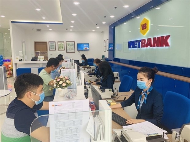 Customers at a Vietbank transaction office in HCM City (Photo courtesy of the bank)