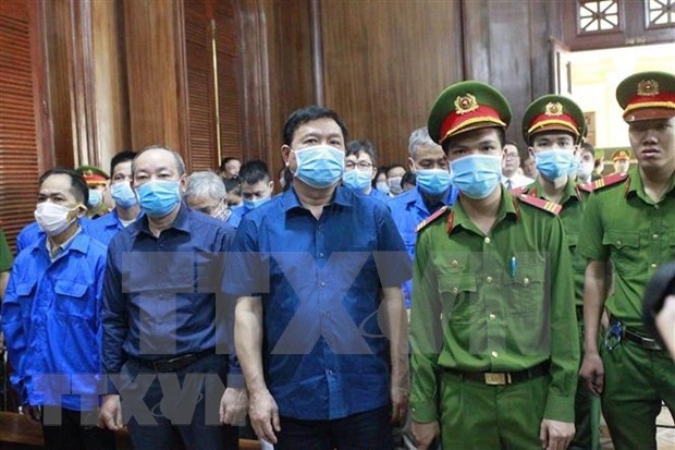 Dinh La Thang, former Minister of Transport, (centre) and Nguyen Hong Truong, former Deputy Minister of Transport, (second, left) are among 20 people involved in bidding and accounting fraud in the HCM City-Trung Luong Expressway project.