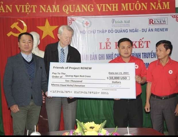 Chuck Searcy (second left), co-founder of Project RENEW, presents funds to flood-affected victims in Vietnam.