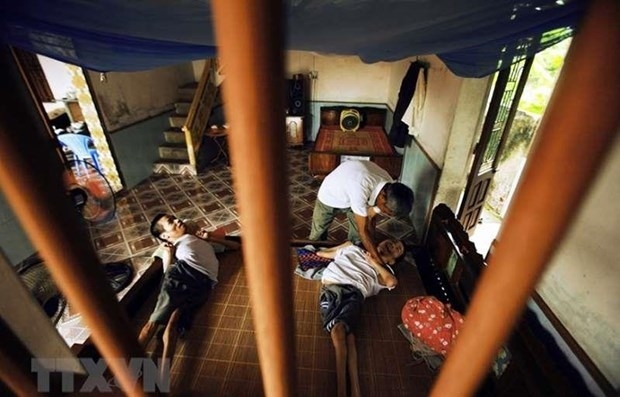 Mr. Lai Van Bien in Vu Thu district, Thai Binh province are caring for his sons affected by Agent Orange (AO)/Dioxin