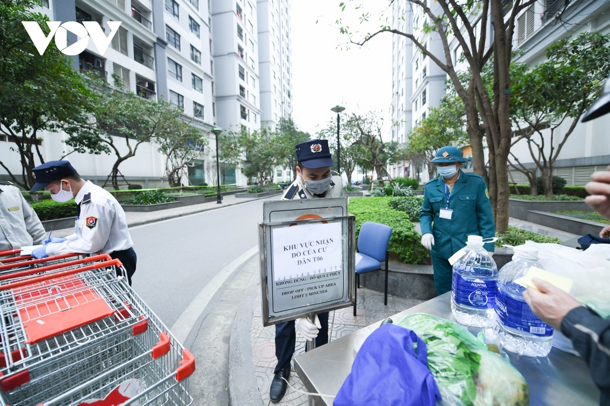 Lots of people come to provide basic necessities for residents inside the apartment block.