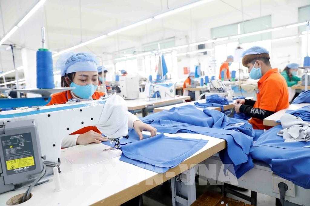 Workers make garments for export to Japan at Hung Viet Garment Company