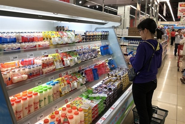 A customer shops for dairy products at a supermarket in HCM City