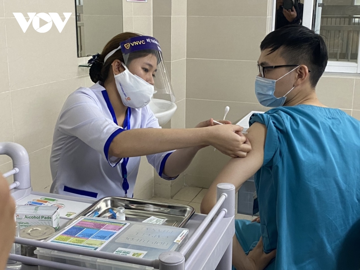 As many as 30 doctors, nurses, and medical nurses from Thanh Nhan Hospital receive their first shot of the COVID-19 vaccine on March 9.