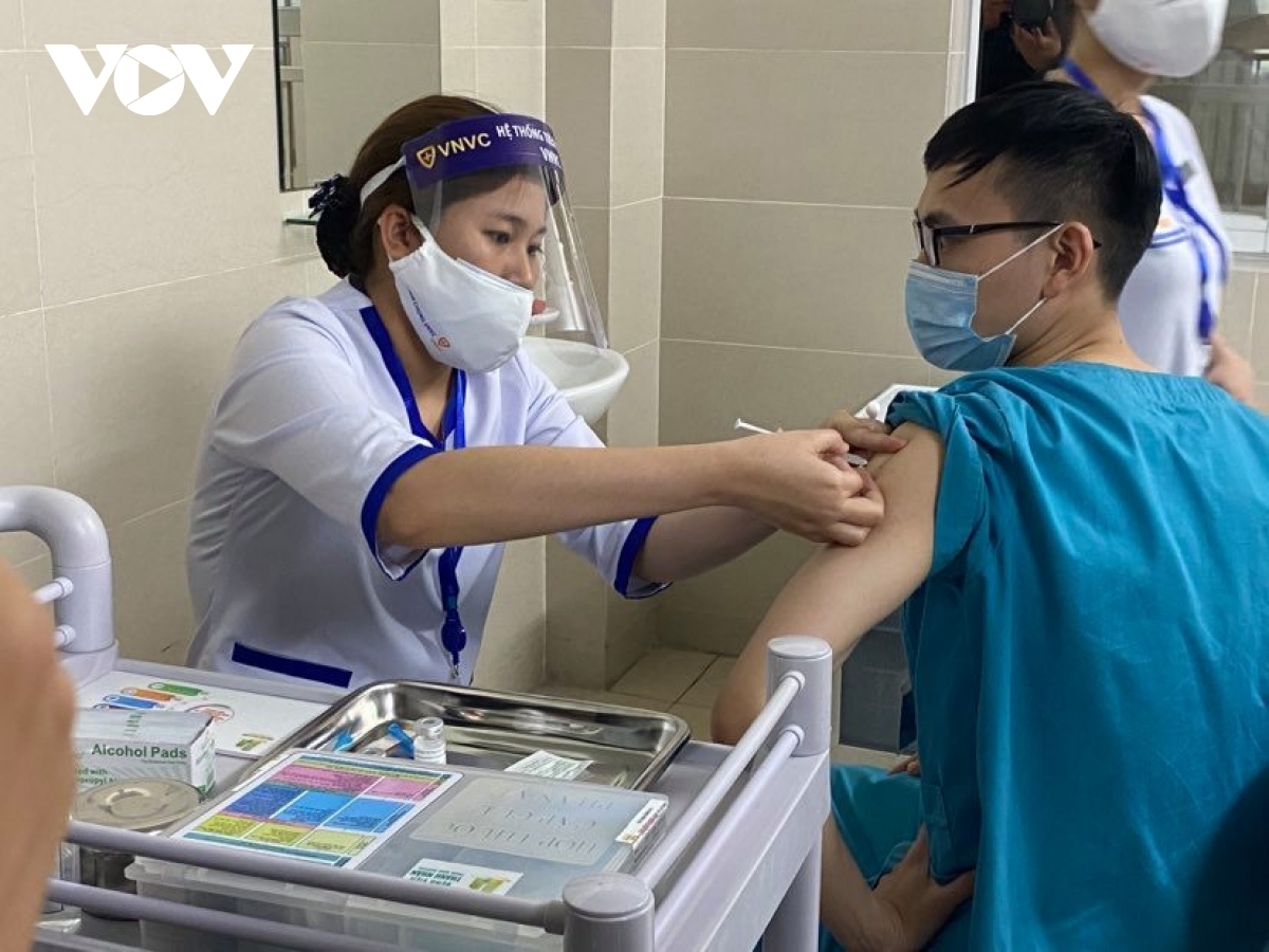A medical worker receives a shot of AstraZeneca vaccine