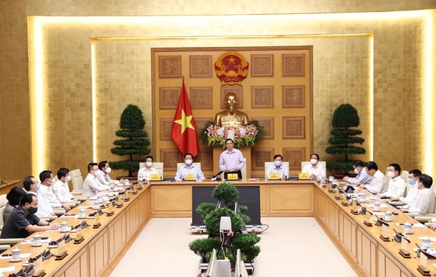 Prime Minister Pham Minh Chinh meets representatives from press agencies on the occasion of the 96th anniversary of Vietnam Revolutionary Press Day (June 21). (Photo: VNA)