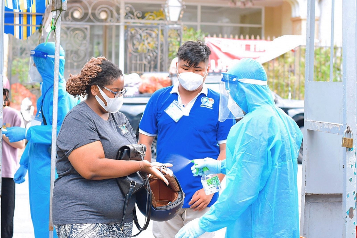 Foreigners are required to wear face masks and use hand sanitizer before entering the inoculation site.