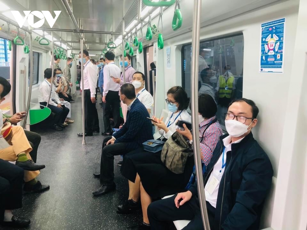 Staff at the station instruct people on how to get a ticket to board the train