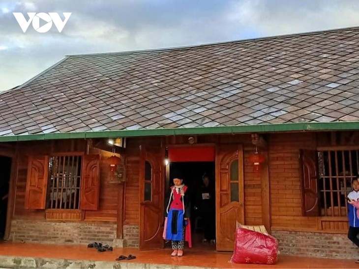 A bride stands outside the groom's house waiting for a ritual to erase all bad luck for her.