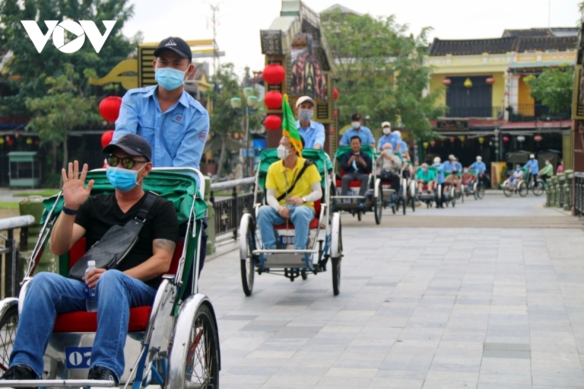 A group of foreign tourists visit the ancient town of Hoi An - a World Heritage site -  on November 20