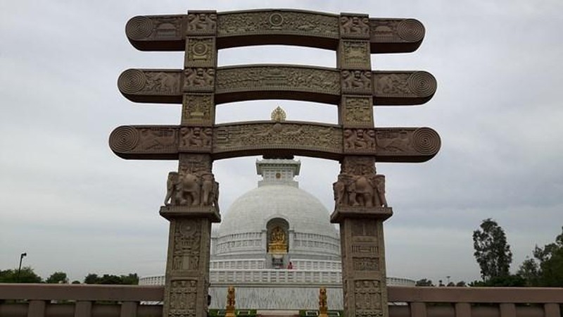 A photograph features Buddhist pagoda-style monument Shanti Stupa.