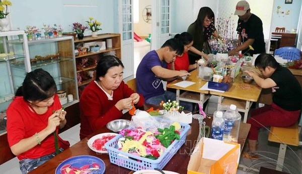 Agent Orange victims learn how to make decorative flowers in the central city of Da Nang.