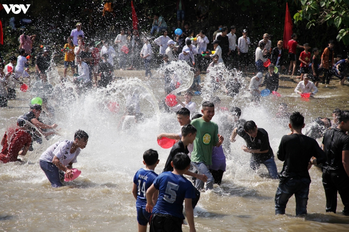 Local residents and visitors enjoy the occasion as they throw and splash water at each other.