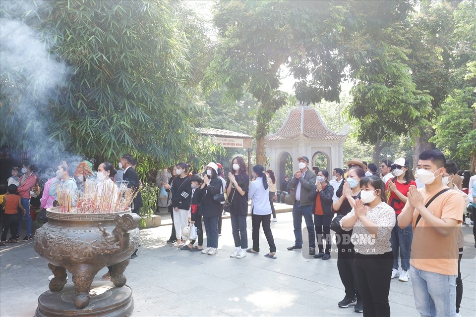 Tourists offer incense at Ha (Lower) Temple, part of the relic complex.