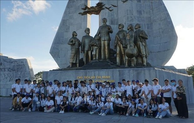 Participants in the Vietnam Summer Camp 2022 pose for a group photo in front of a monument to President Ho Chi Minh in Quang Binh province.