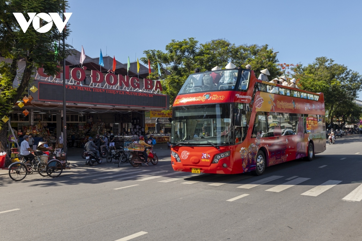 The double-decker bus passes through Dong Ba market - a tourist destination in Hue.