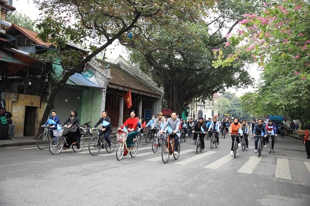 Participants cycle on a street around Hoan Kiem Lake on December 11. (Photo: VNA)