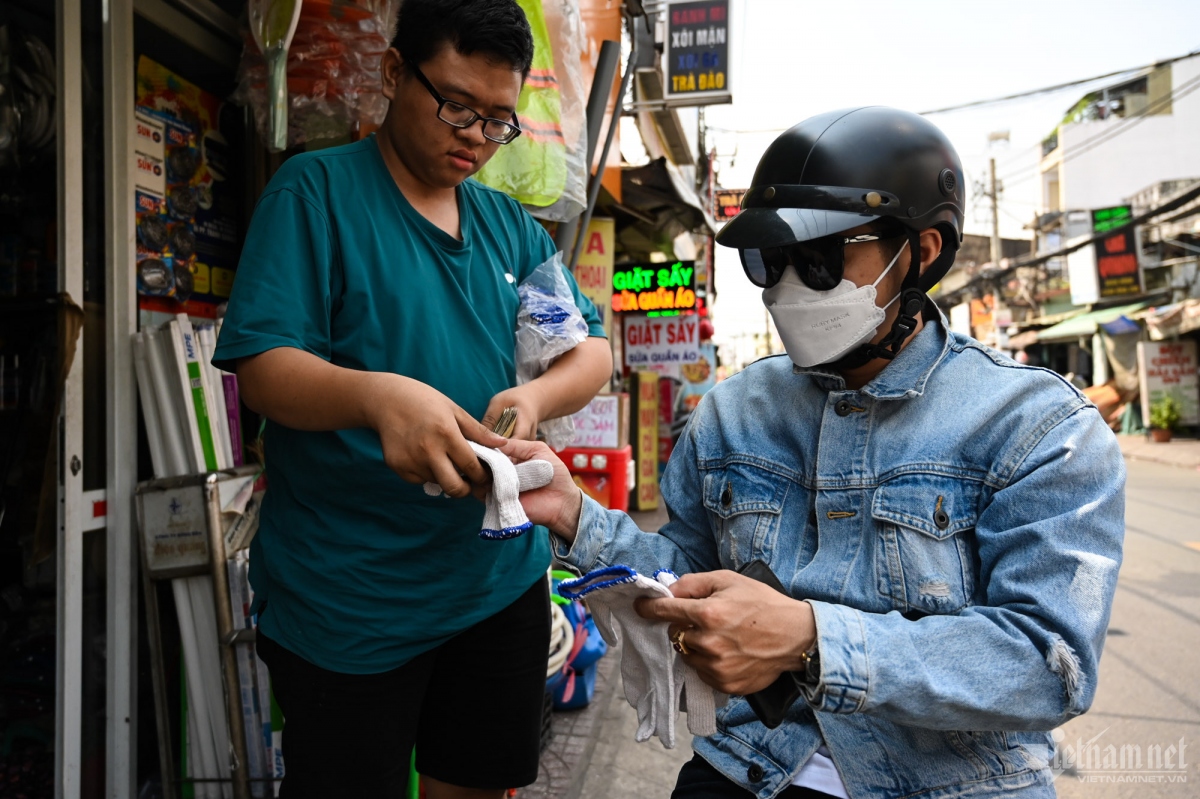 A local buys gloves costing VND10,000 to protect their skin from sunlight exposure.