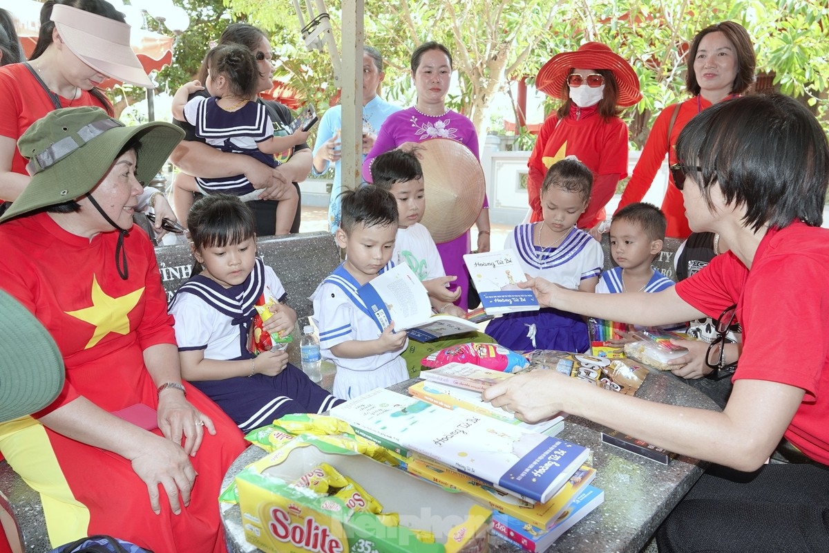 The delegation presents gifts to local children who reside on the island.