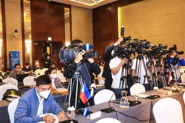 Reporters work at a press conference.