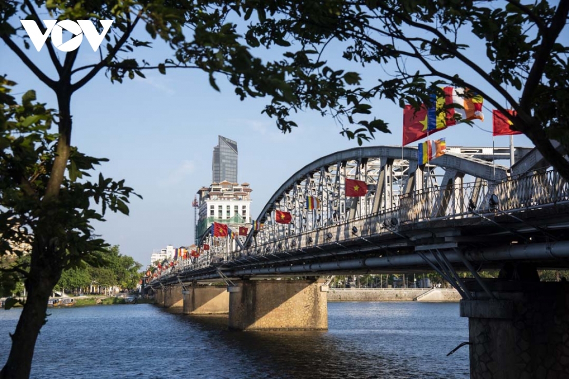National and Buddhist flags are hung around Truong Tien bridge.