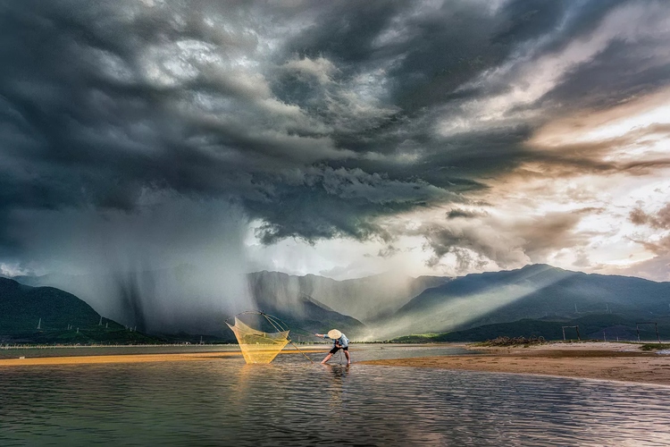 Vietnamese photographer Phan Thi Khanh with her entry "In the Storm" wins prize at Pink Lady photo contest.
