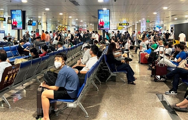 Passengers waiting to board a plane at Tan Son Nhat International Airport.