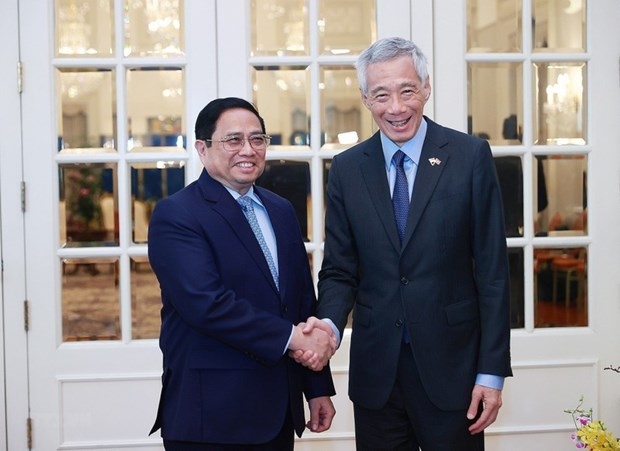 Prime Minister Pham Minh Chinh (L) meets Singaporean Prime Minister Lee Hsien Loong in Singapore on February 9, 2023 (Photo: VNA)