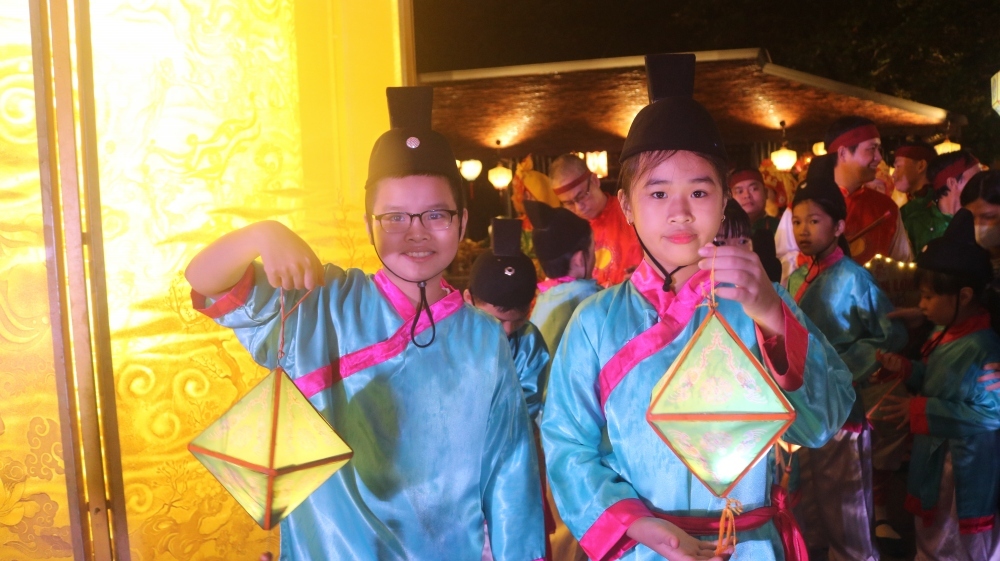 Children re-enact a lantern parade inside the Hue Imperial Citadel.