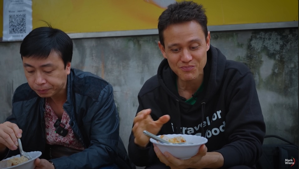Mark Wiens enjoys Xôi xéo (Vietnamese sticky rice with mung bean) in Hanoi