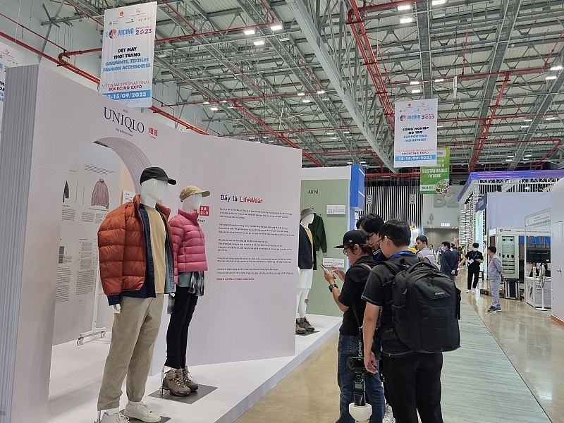 Participants visit a booth of Japanese fashion brand Uniqlo