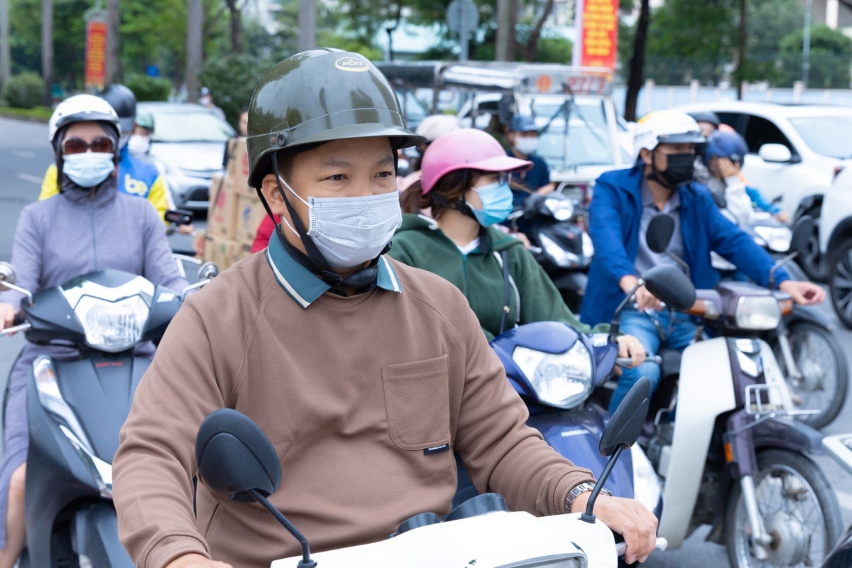 Motorcycle riders bundle up with many layers and accessories, including masks, hats, and coats to keep out the wind chill.