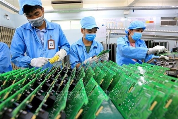 Worhers handle circuit boards of electronic meters.