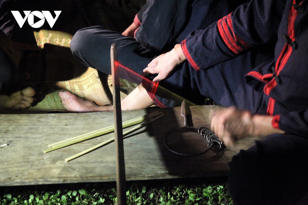 Before performers dance on burning coals, an oracle sits on a long bench to worship God.
