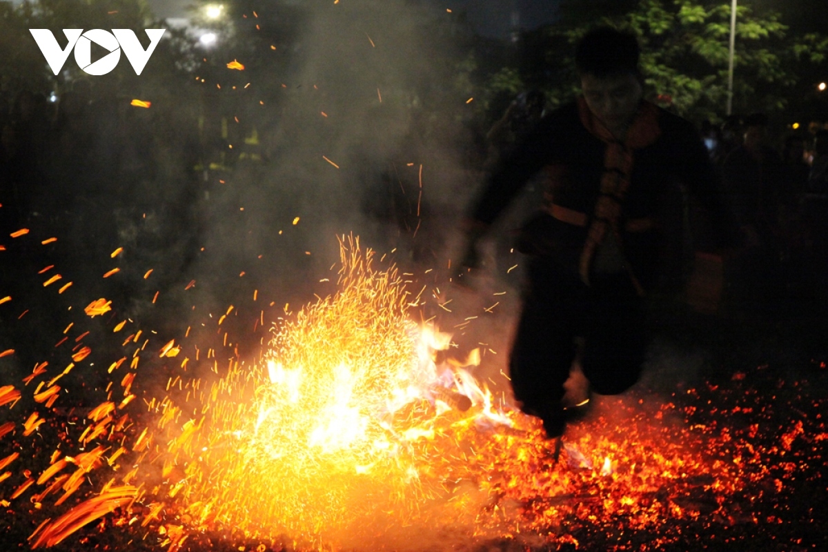 Young men jump over a coal fire without fear and are able to come away unscathed.