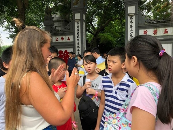 Students practise speaking English with a foreigner near Hanoi’s Hoan Kiem Lake. Hanoi has among the highest levels of English proficiency in Vietnam.