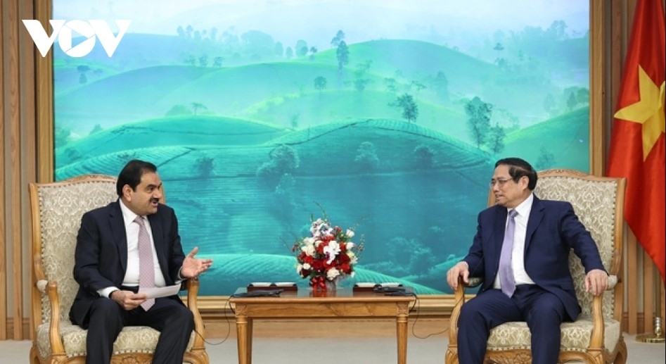 Prime Minister Pham Minh Chinh (R) receives Chairman of Adani Group Gautam Adani