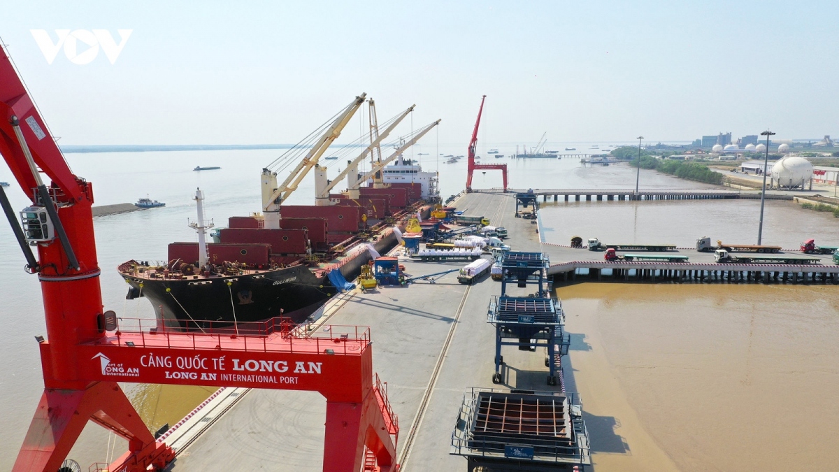 Loading and unloading goods at Long An international port, southern Vietnam.