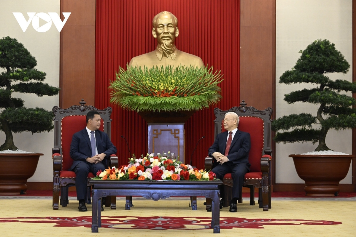 Vietnamese Party General Secretary Nguyen Phu Trong (R) receives Cambodian Prime Minister Hun Manet in Hanoi on December 11