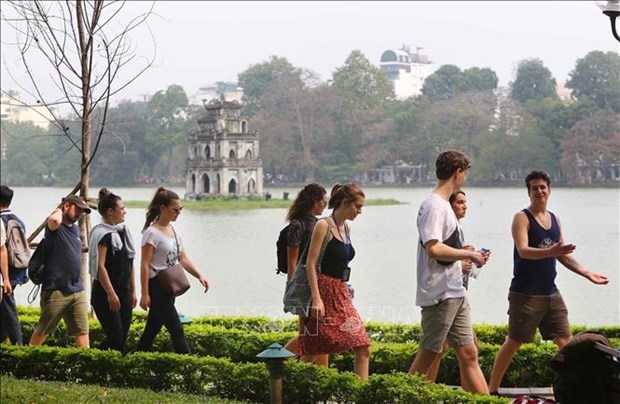Foreign tourists visit Hoan Kiem lake in Hanoi.