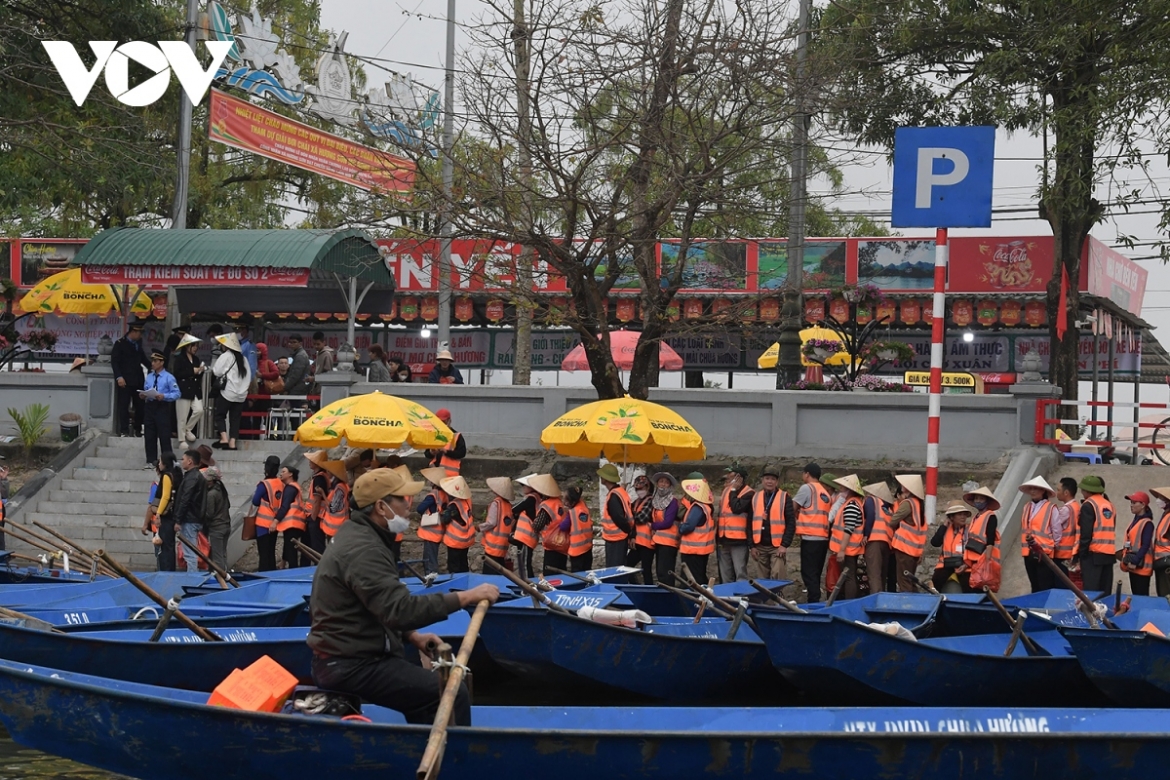 Rowing boats are arranged in line as they transport pilgrims and tourists to the main shrines across the site. 