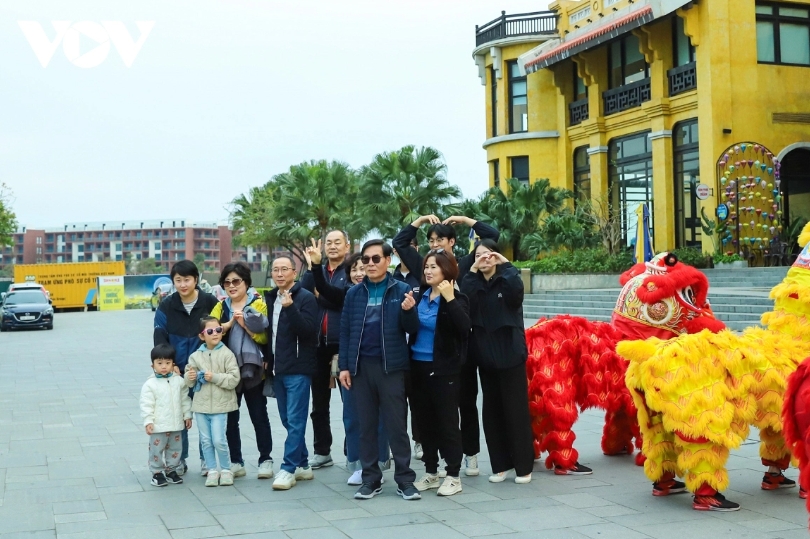 Families pose for photos before boarding the ship to tour Ha Long Bay