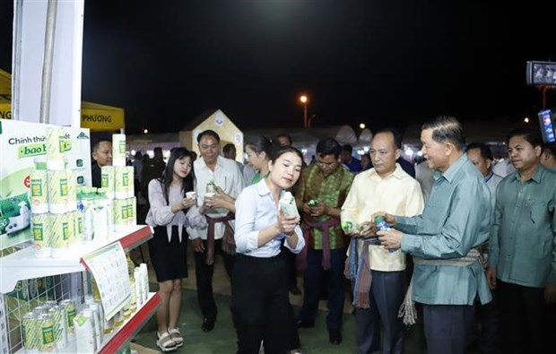 Officials visit a booth at the exhibition.