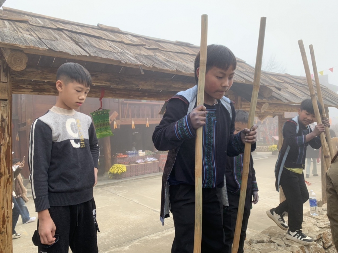 A local child shows off his stilt walking skills.