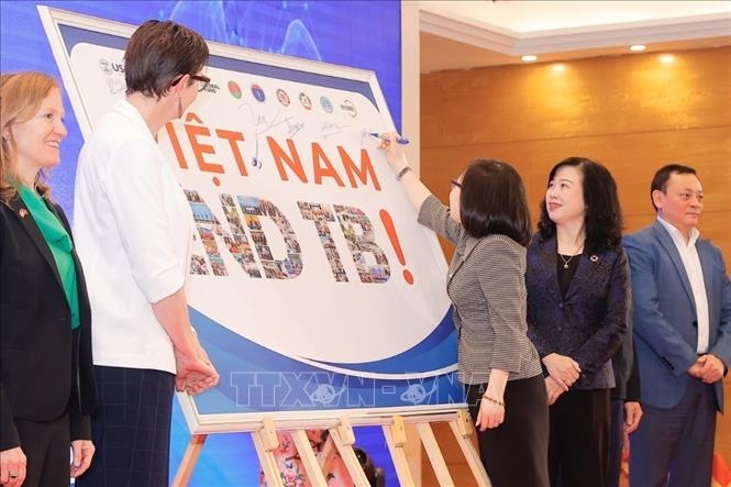 Delegates sign a board to show the high determination that exists to put an end to TB in Vietnam.