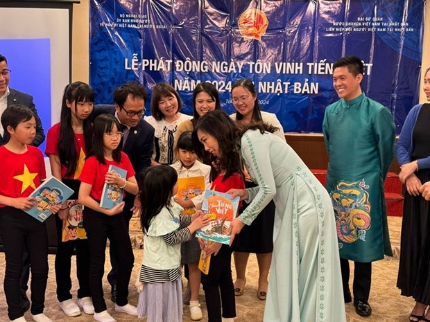 Vietnamese Deputy Minister of Foreign Affairs Le Thi Thu Hang presents Vietnamese language textbooks to students at the event (Photo: VNA)