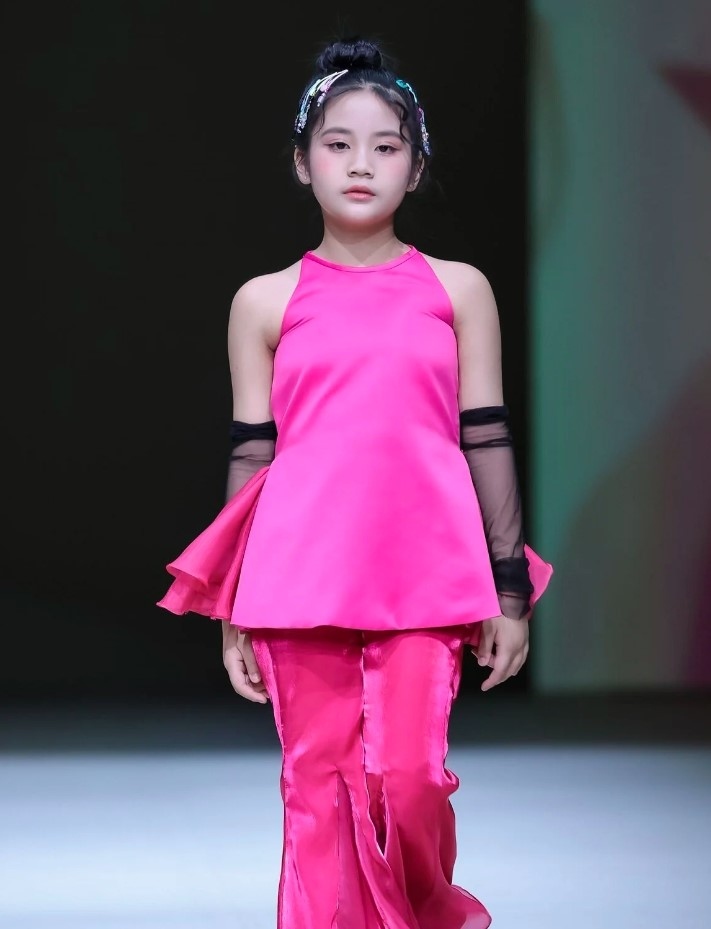 Ten child models in outfits showcasing Vietnamese culture strut down the runway at this year's Shanghai Fashion Week.