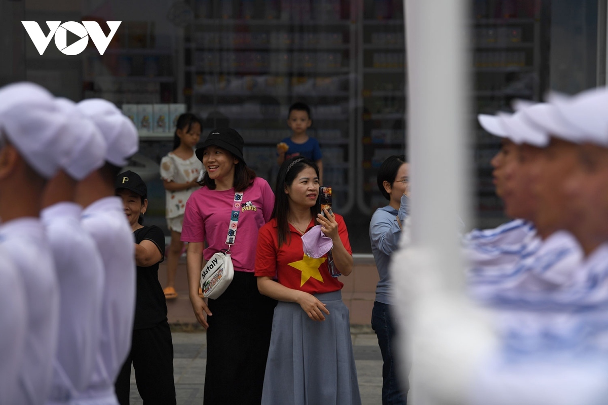 Although it is a rehearsal, residents in Dien Bien city line up along streets to watch armed forces parade through.