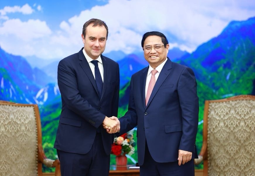 Vietnamese Prime Minister Pham Minh Chinh (R) shaking hands with French Minister of the Armed Forces Sebastien Lecornu ahead of their meeting in Hanoi on May 6. (Photo: VGP)